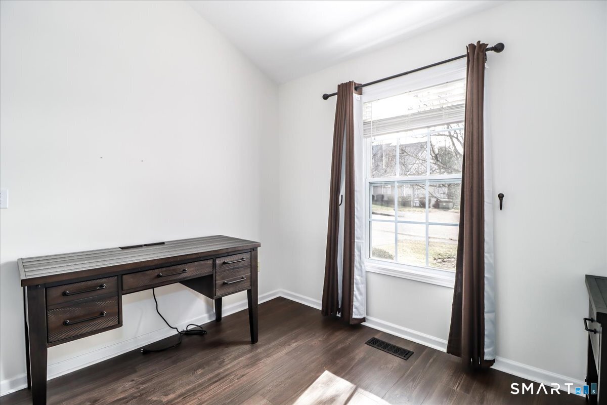87 Haley Lane, Unit 87 Newtown, CT 06482 - Photo 9 of 39 a view of a room with wooden floor and small window