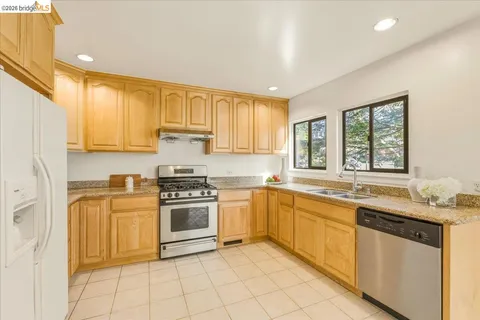 a kitchen with a stove sink and cabinets