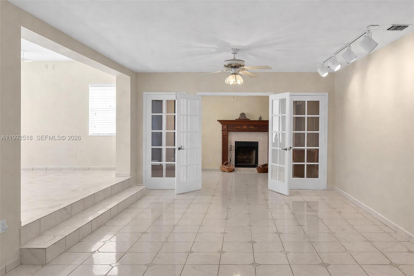5309 Alton Road Miami Beach, FL 33140 - Photo 8 of 51 a view of an empty room with a fireplace and a window