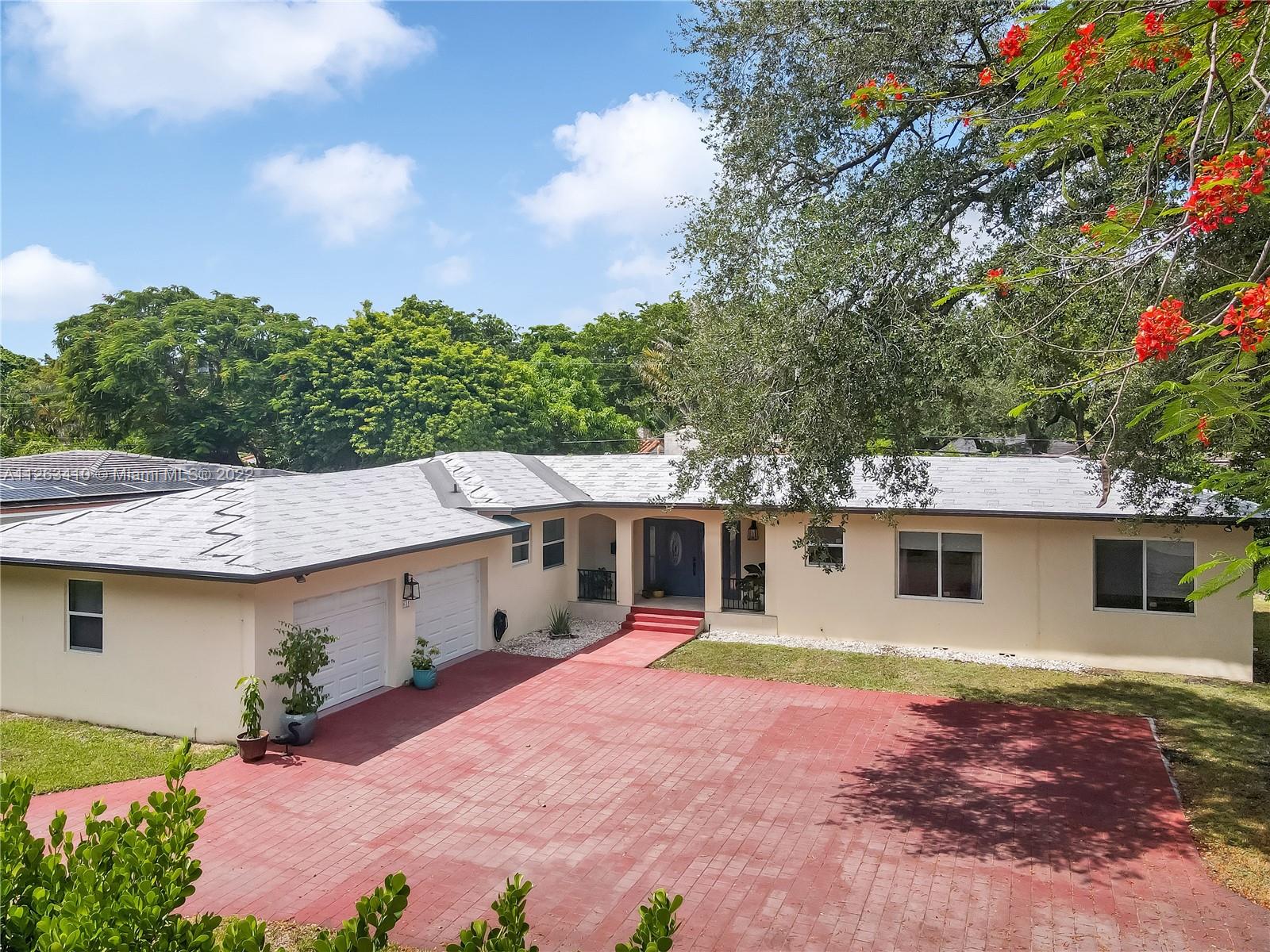 635 Bird Road Coral Gables, FL 33146 - Photo 1 of 35 a view of a house with a yard and potted plants