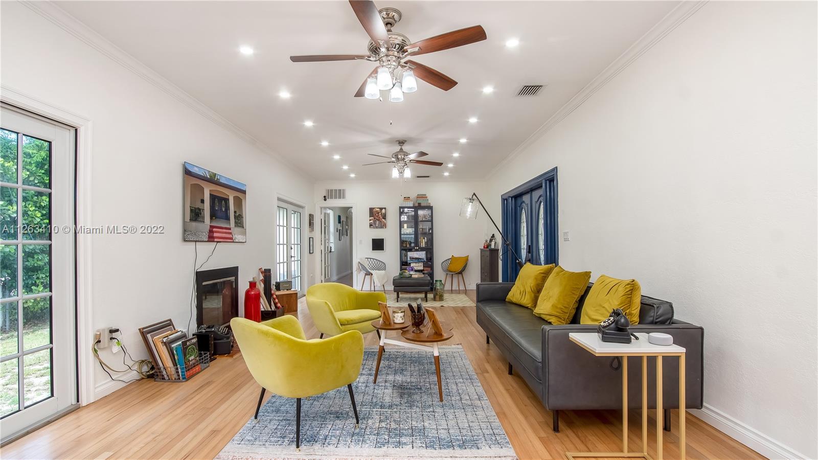 635 Bird Road Coral Gables, FL 33146 - Photo 11 of 35 a living room with furniture and a flat screen tv