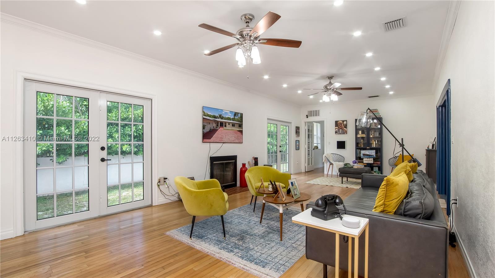 635 Bird Road Coral Gables, FL 33146 - Photo 12 of 35 a living room with furniture and a chandelier
