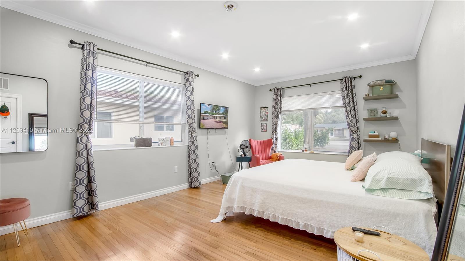 635 Bird Road Coral Gables, FL 33146 - Photo 21 of 35 a bedroom with a bed and wooden floor