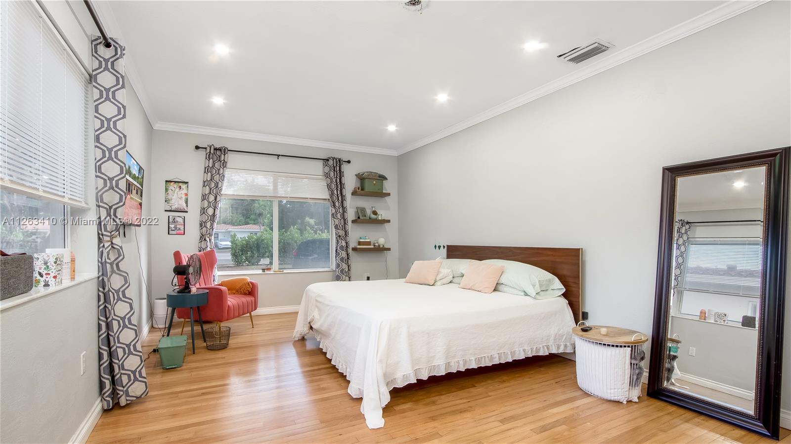 635 Bird Road Coral Gables, FL 33146 - Photo 22 of 35 a bedroom with a bed and wooden floor