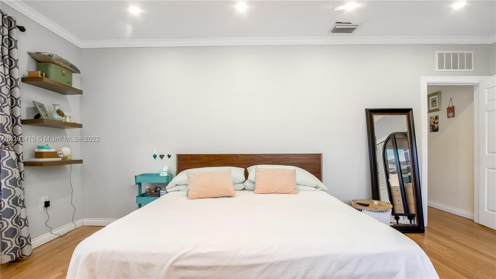 635 Bird Road Coral Gables, FL 33146 - Photo 23 of 35 a bedroom with a bed and a flat tv screen on the dresser