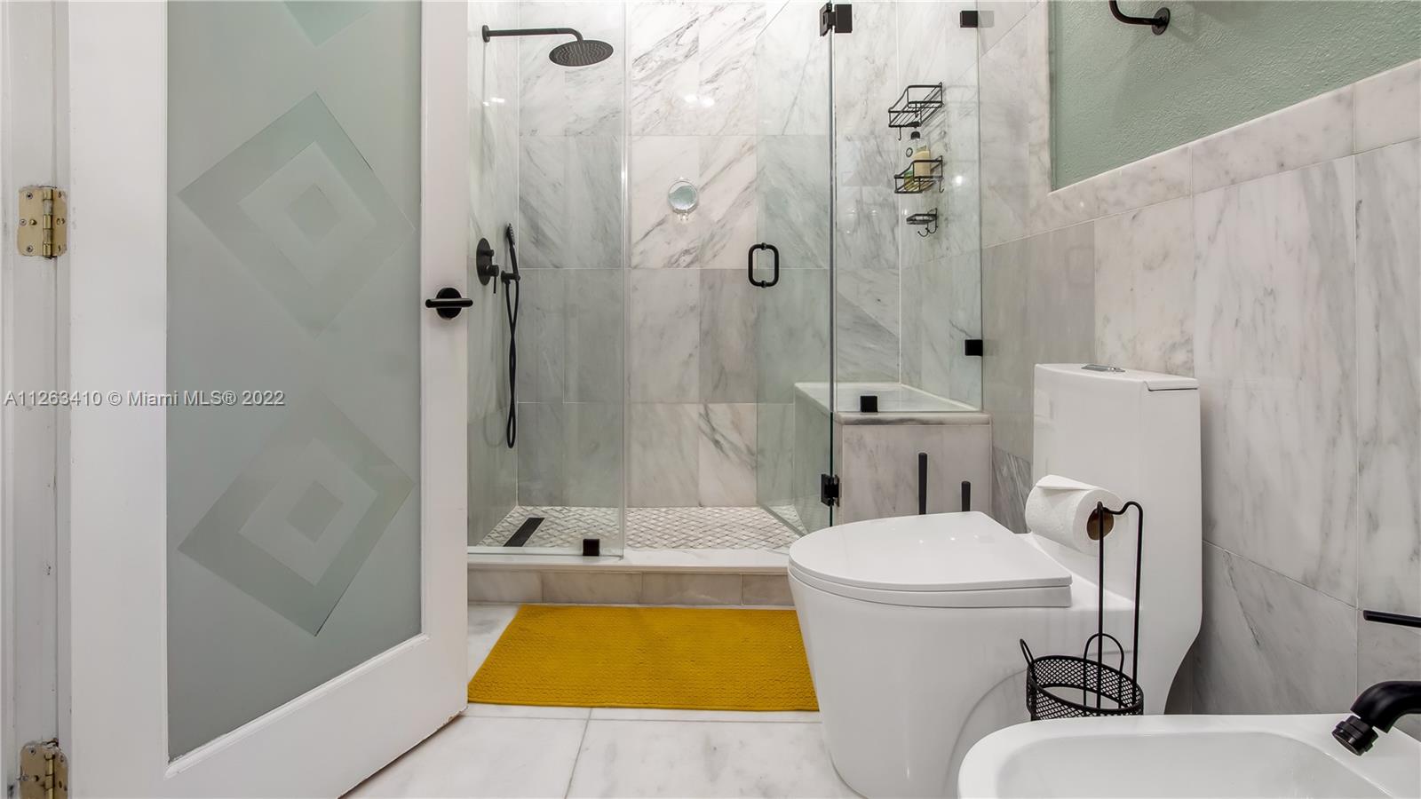 635 Bird Road Coral Gables, FL 33146 - Photo 26 of 35 a bathroom with a sink a toilet and shower