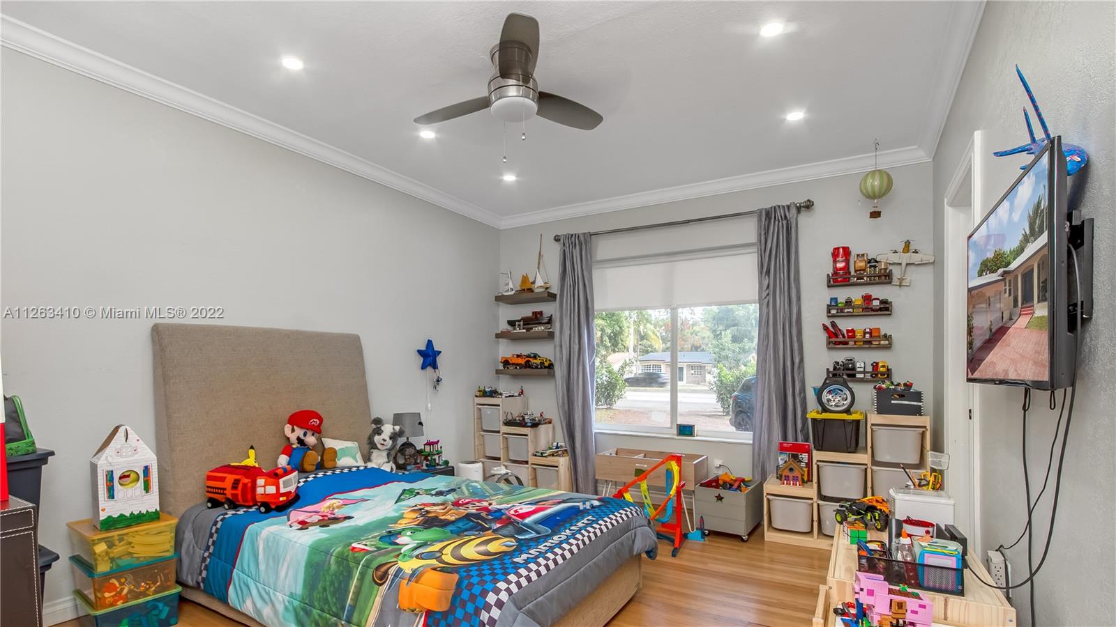 635 Bird Road Coral Gables, FL 33146 - Photo 28 of 35 a bed room with a bed and a wooden floor