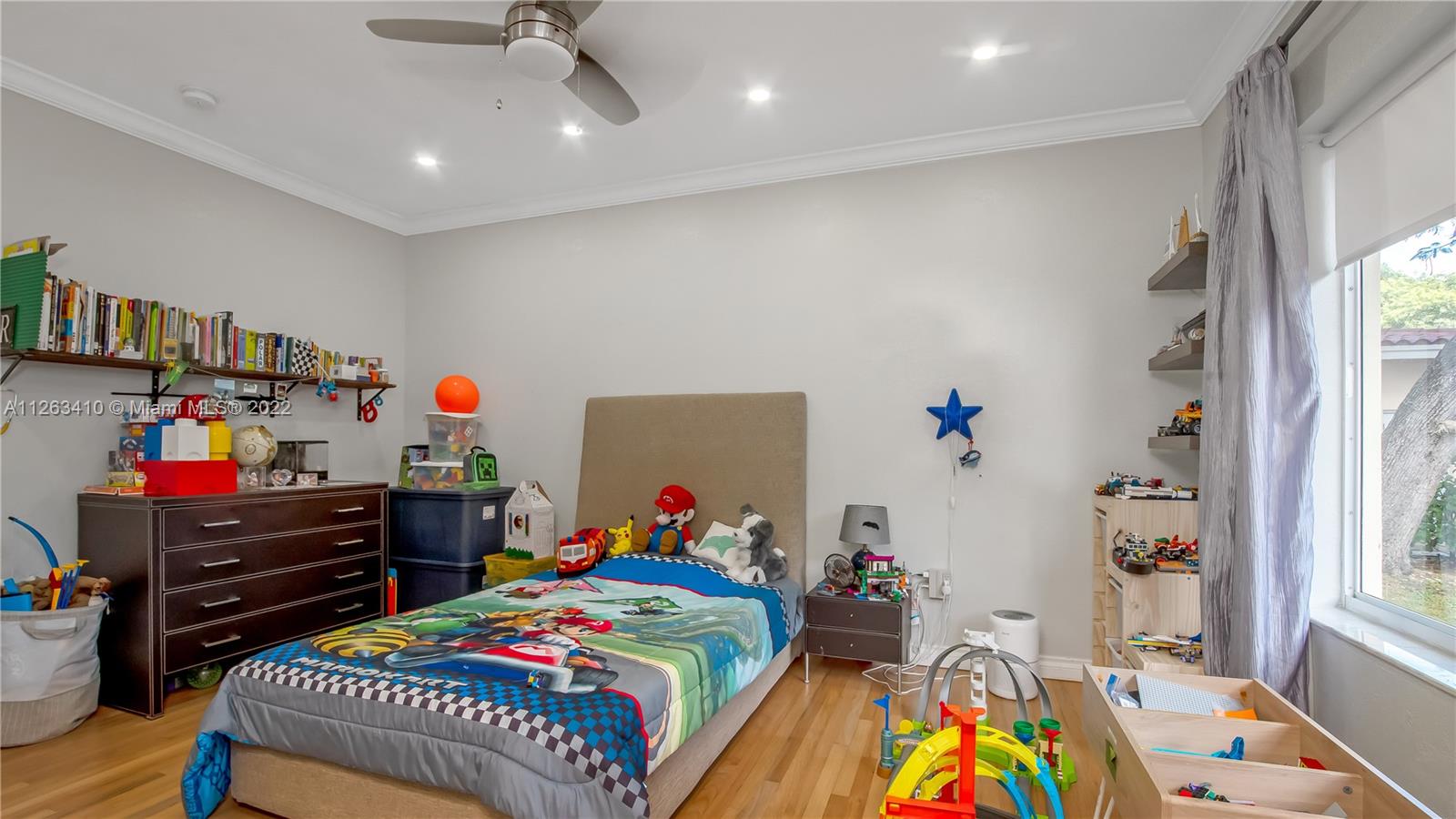 635 Bird Road Coral Gables, FL 33146 - Photo 29 of 35 a bedroom with a bed and wooden floor