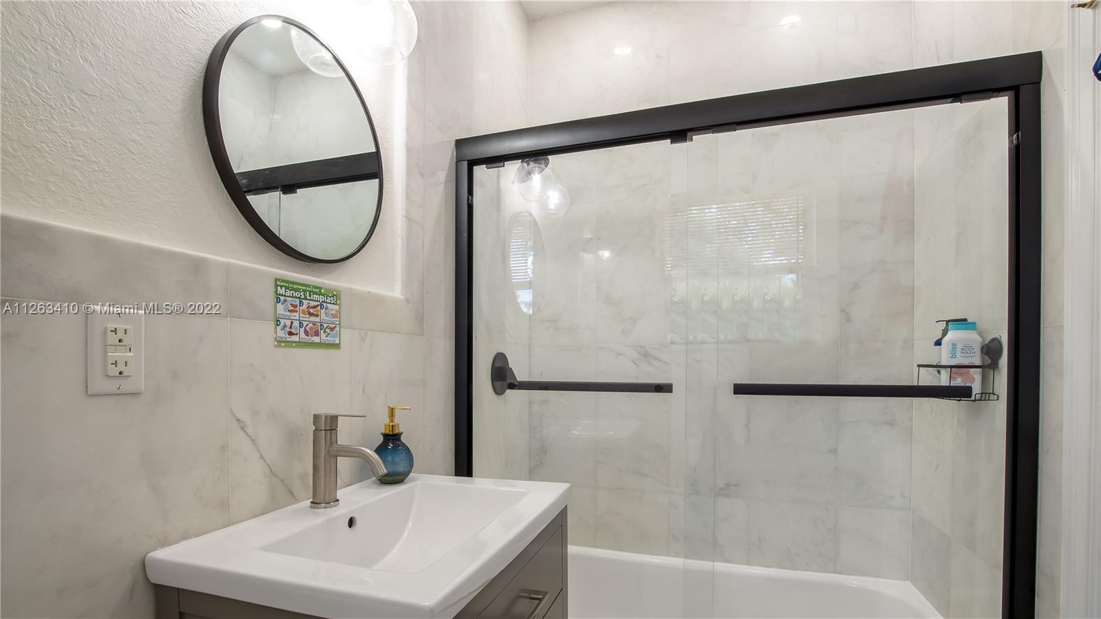 635 Bird Road Coral Gables, FL 33146 - Photo 30 of 35 a bathroom with a sink and a mirror