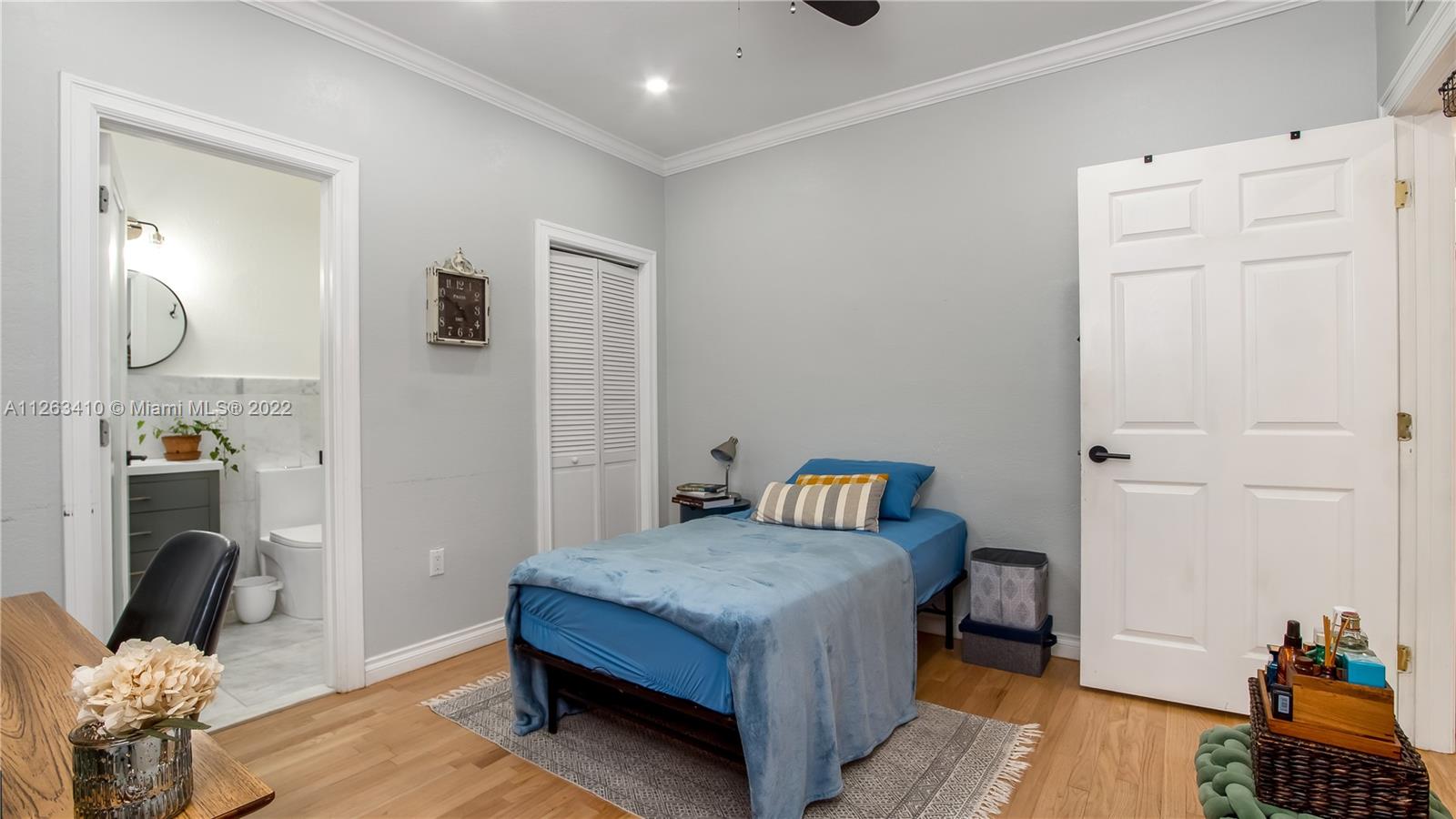 635 Bird Road Coral Gables, FL 33146 - Photo 33 of 35 a bedroom with a bed and wooden floor