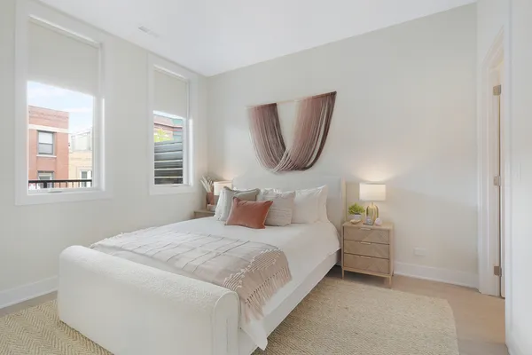 a bedroom with a bed and a lamp