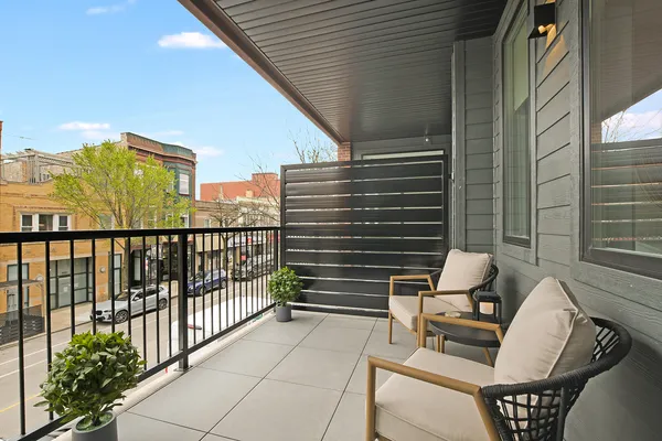 a view of a balcony with floor to ceiling window wooden floor