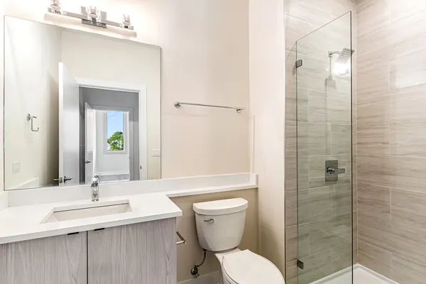 a bathroom with a sink toilet and shower