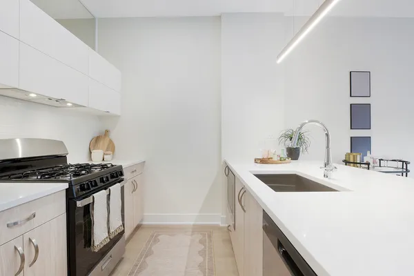 a kitchen that has a sink and a stove