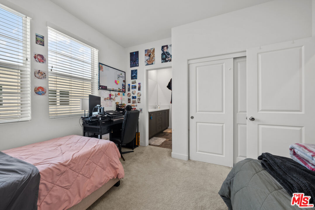 27034 Hummingbird Lane Valencia, CA 91381 - Photo 13 of 24 a bedroom with a bed and a refrigerator