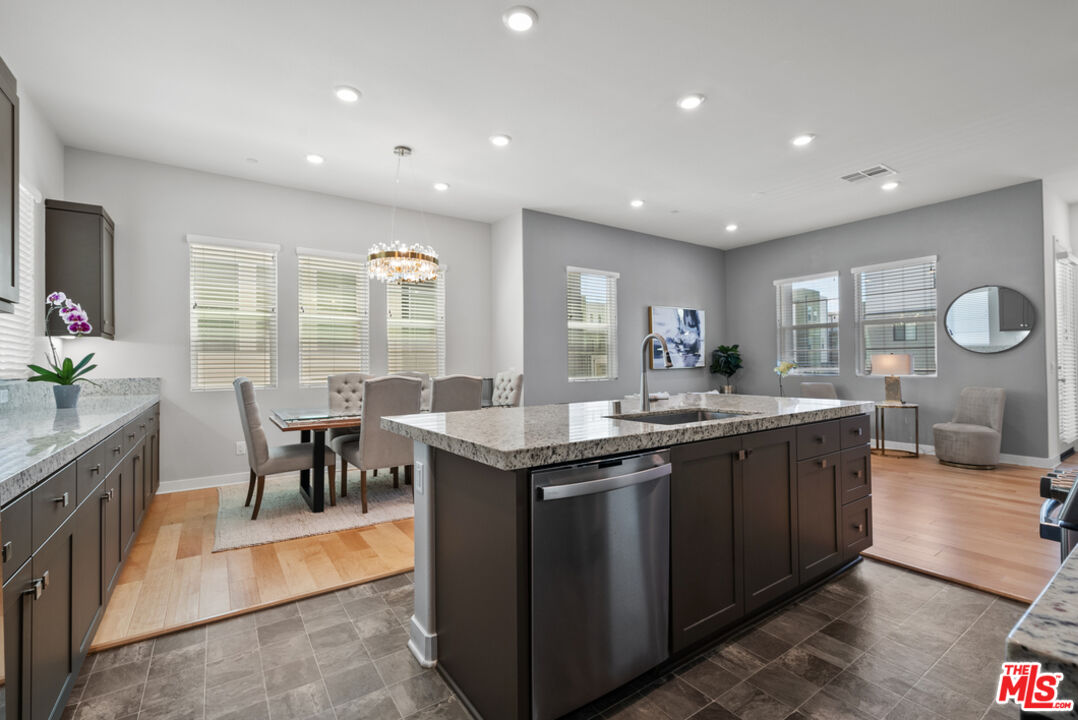 27034 Hummingbird Lane Valencia, CA 91381 - Photo 8 of 24 a kitchen with granite countertop a sink and stove