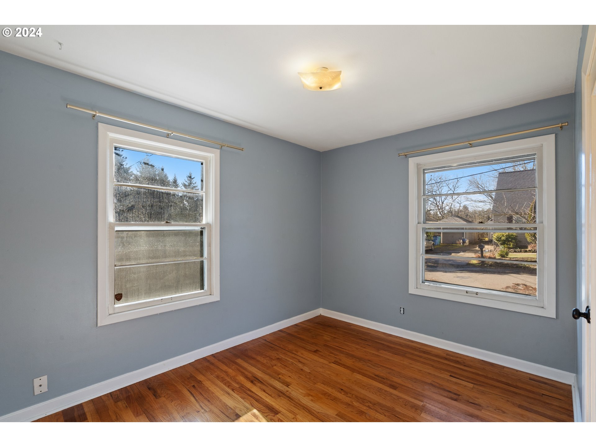 4313 Northeast Valley View Lane Vancouver, WA 98663 - Photo 27 of 48 a view of an empty room with wooden floor and a window