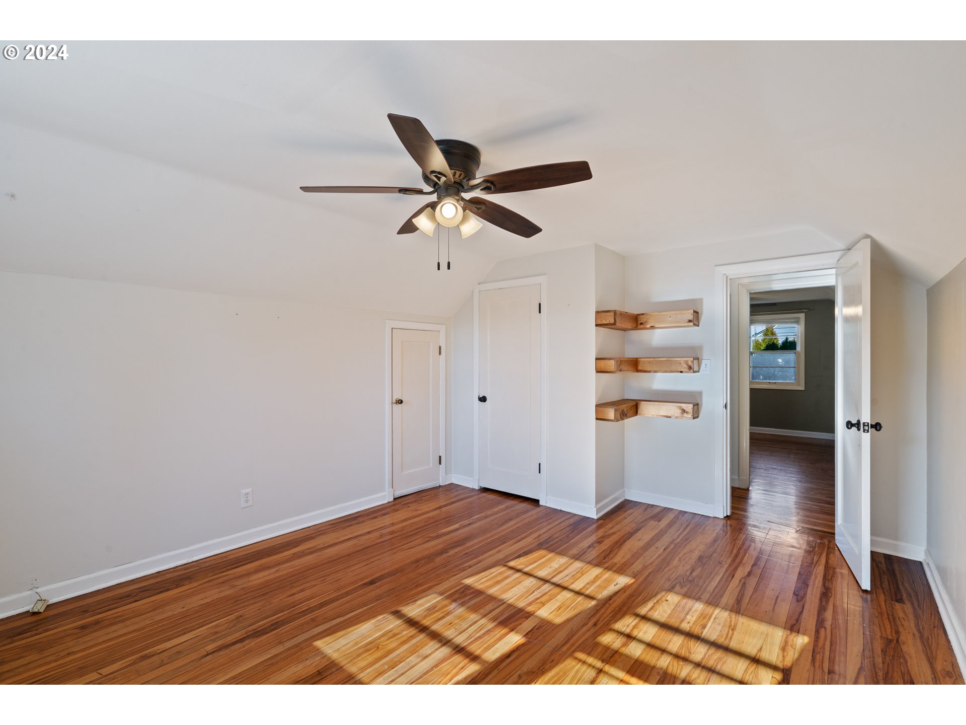 4313 Northeast Valley View Lane Vancouver, WA 98663 - Photo 31 of 48 a view of a room with wooden floor and a ceiling fan