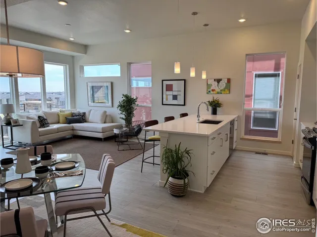 a living room with fireplace furniture and a large window