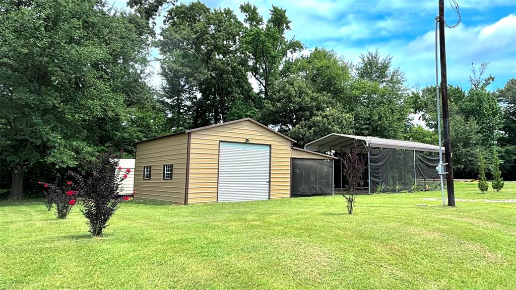 821 Waterfront Row Quitman, TX 75783 - Photo 1 of 1 a front view of a house with a yard and garage