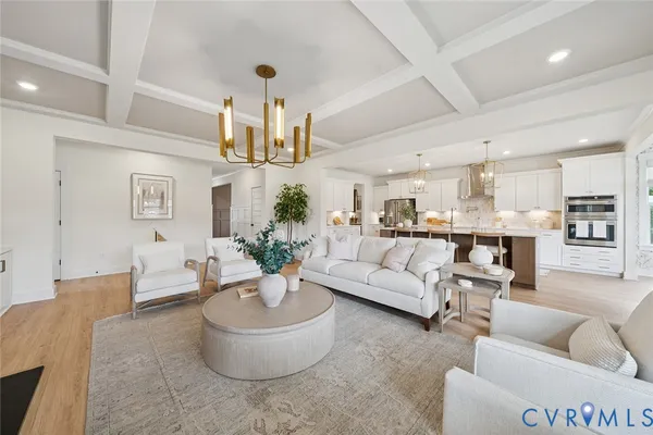 a living room with furniture and a view of kitchen