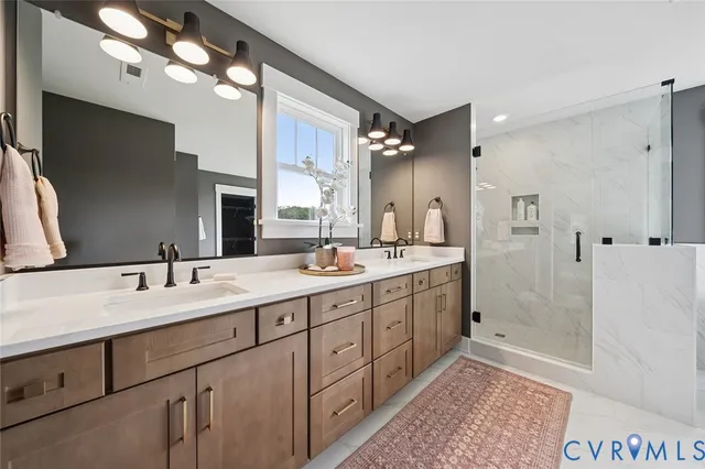 a spacious bathroom with double sink and a mirror