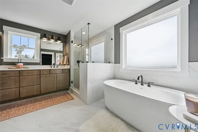 a spacious bathroom with a sink mirror and a bathtub