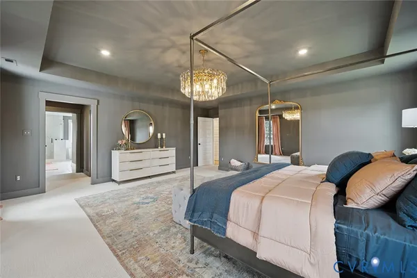 a bedroom with a bed and a chandelier