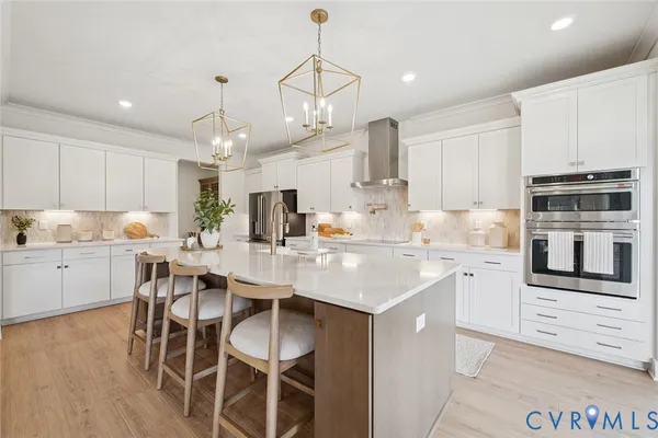 a kitchen with appliances a sink and cabinets
