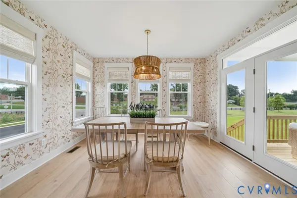 a view of a dining room with furniture window and wooden floor