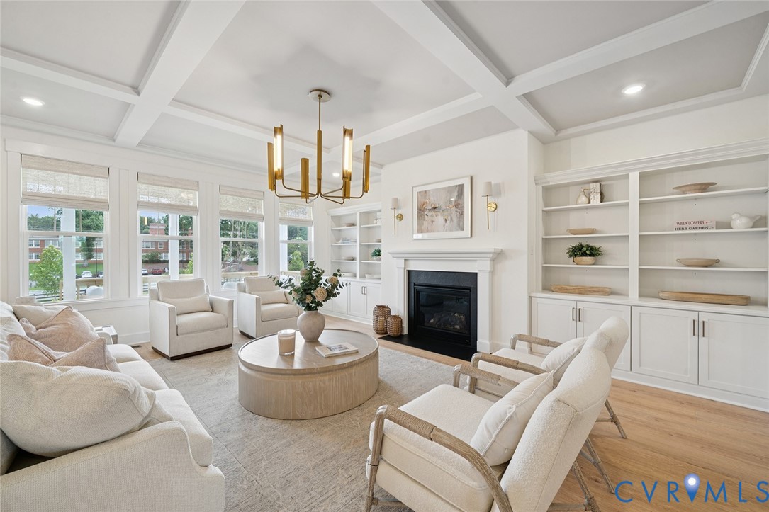 3092 Reed Marsh Drive Goochland, VA 23063 - Photo 10 of 36 a living room with furniture a fireplace and a chandelier