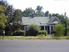 a front view of house with yard and trees