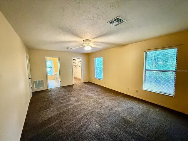 an empty room with windows and entrance