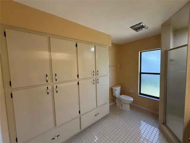 a bathroom with a shower and a toilet