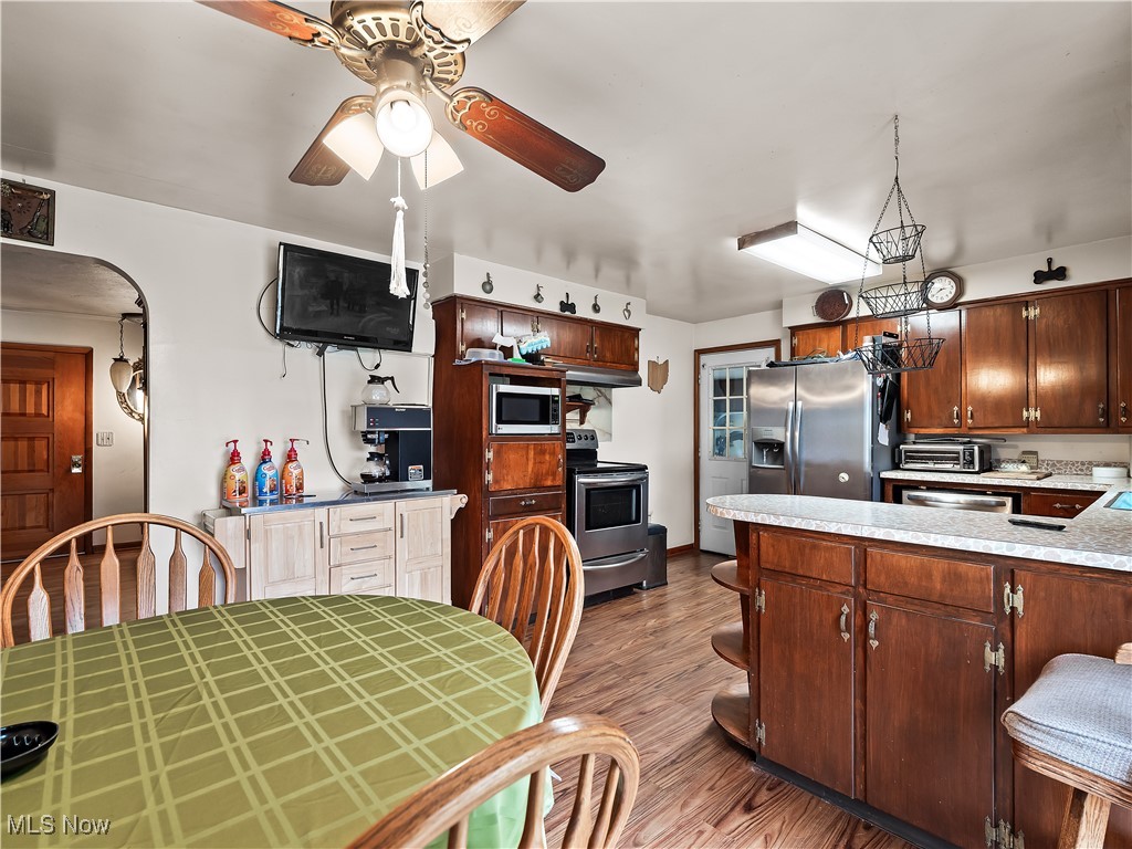9049 Oberlin Road Elyria, OH 44035 - Photo 12 of 42 Kitchen with a peninsula, light countertops, dark wood-style floors, stainless steel appliances, and ceiling fan