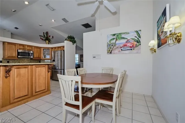 a view of a dining room with furniture and a kitchen view