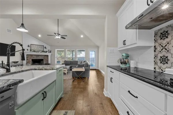 a kitchen with sink stove and cabinets