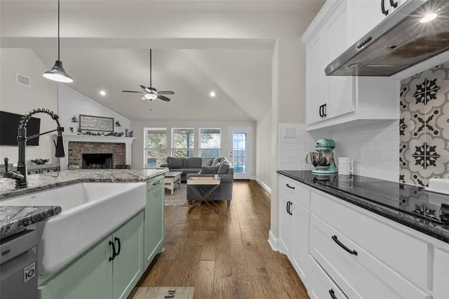 a kitchen with sink stove and cabinets