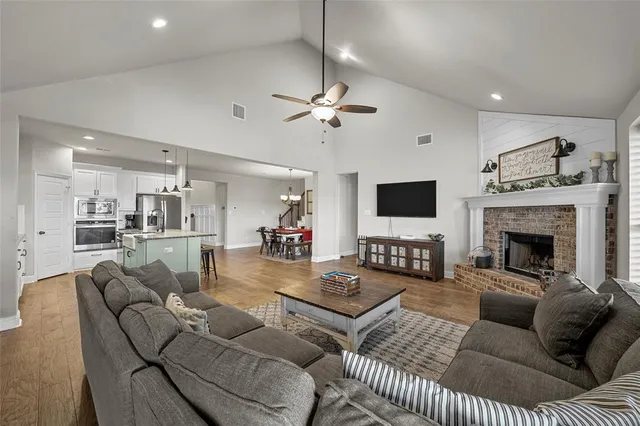 a living room with furniture a fireplace and a flat screen tv