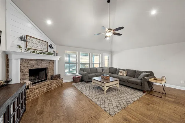 a living room with furniture a fireplace and a chandelier
