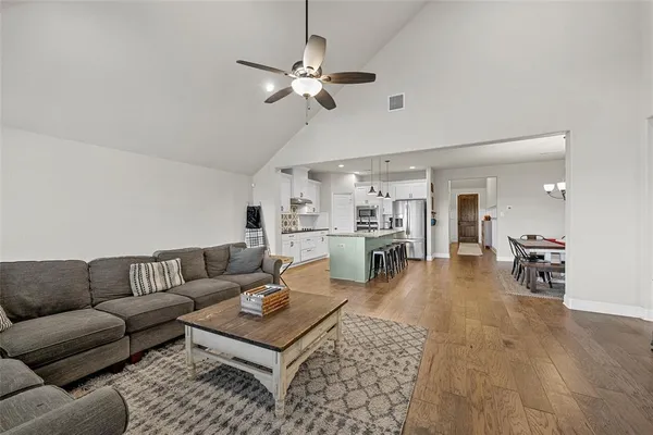 a living room with furniture and a chandelier