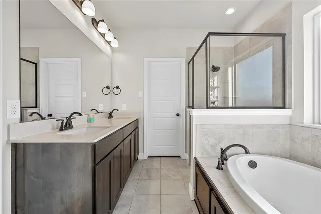 a bathroom with a tub sink and mirror