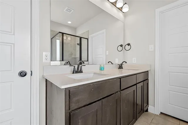 a bathroom with a sink vanity and mirror