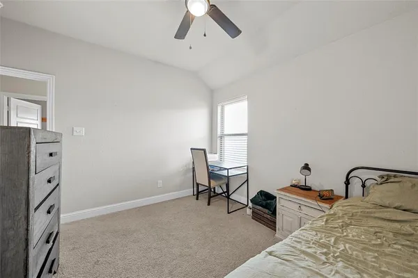 a bedroom with a bed dresser and a window