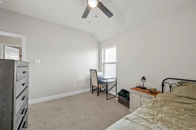a bedroom with a bed dresser and a window
