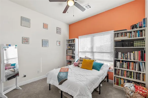 a bedroom with a bed and a book shelf