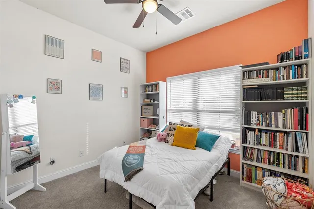a bedroom with a bed and a book shelf