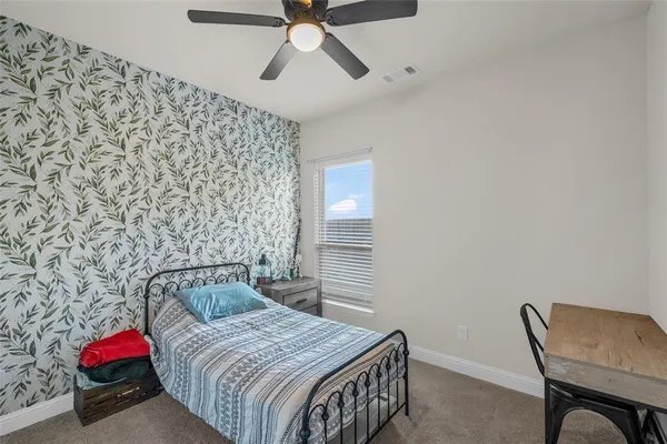 a bedroom with a bed and a chair