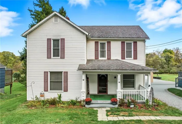 a front view of a house with a yard and porch