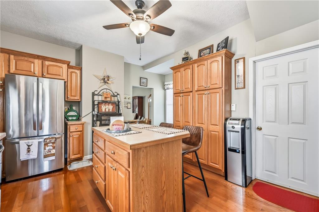 181 West Jamestown Road Greenville, PA 16125 - Photo 26 of 49 a kitchen with stainless steel appliances granite countertop a refrigerator a stove a sink dishwasher and a dining table with wooden floor